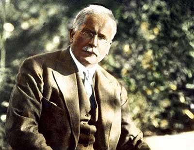 Photo of Carl Jung sitting, green background